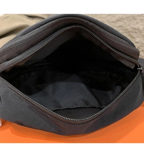 Close-up view of the interior compartment and metal zipper of the black crossbody bag