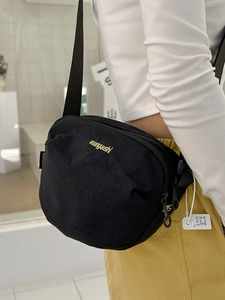 Versatile black nylon crossbody bag with adjustable strap and brand embroidery detail