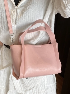 Pink lychee grain leather bucket bag with top handles and adjustable strap for women