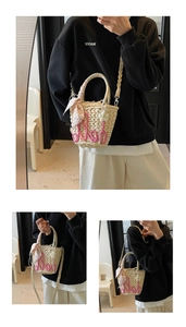 Detailed view of straw handbag with pink rope letter embroidery and floral silk scarf charm