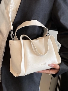 Minimalist white bucket bag with wave pleats and shoulder strap for women