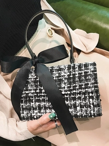 Elegant black and white tweed crossbody bag with a large decorative black bow for women