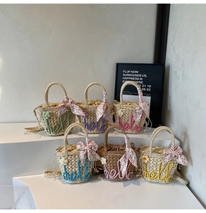 Detailed macro view of six mini straw woven handbags with hello floral embroidery