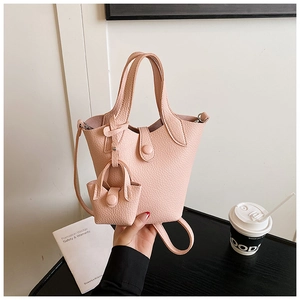 Detail of pink lychee pattern bucket bag with mini pouch and magnetic closure