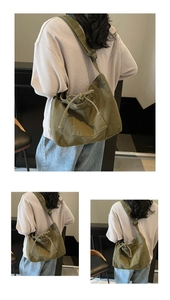 Detailed view of army green canvas tote with drawstring pocket and adjustable strap