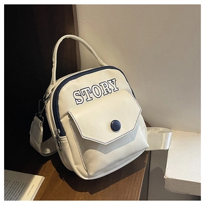 Détail d'un mini sac à dos blanc avec logo STORY bleu et large bandoulière tissée