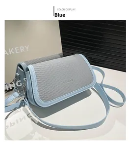 Detail showing the light blue woven texture and leather panel on this stylish crossbody bag