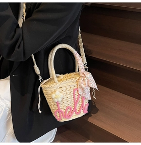 Straw basket bag with hello embroidery and floral scarf detail shown worn cross-body