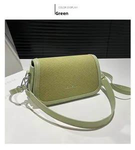 Detail showing green woven texture and metal logo on fashion shoulder bag