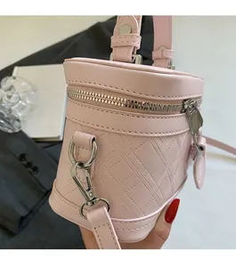 Close-up of pink bucket bag featuring quilted leather texture and silver hardware details