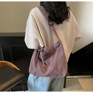 Detail of deep purple canvas tote bag showing the vintage cargo style and large capacity