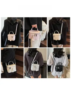 Three-color quilted box handbag shown on a model with hand-carried and crossbody styling