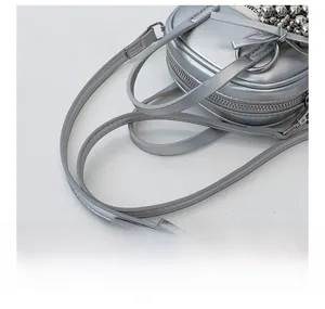 Detail showing the adjustable shoulder strap mechanism on a silver metallic handbag