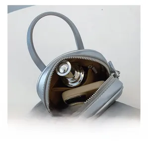 Detail view of the silver-grey leather crossbody bag interior with card slot compartments