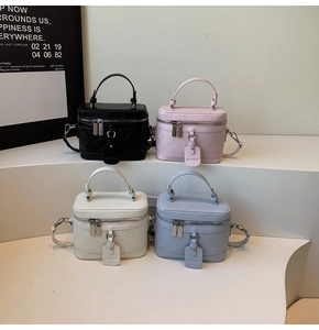 Detail view of box-shaped crossbody bags in four colors with quilted texture and dual zippers