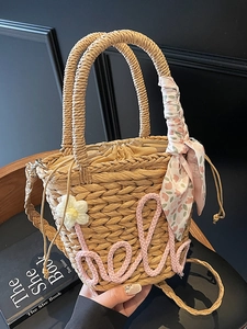 Handwoven straw tote bag with pink Hello design and floral scarf handle for beach vacation