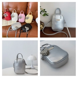 Detail view of mini PU leather crossbody bags in various colors with heart bead charms