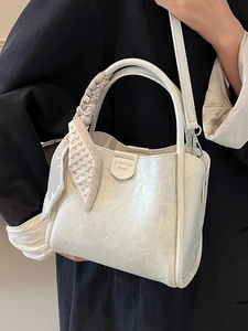 Chic cream leather bucket bag with decorative scarf and shoulder strap for women