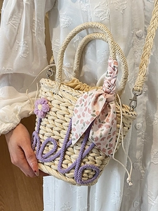 Handmade woven straw bucket bag with purple love embroidery and floral silk scarf detail