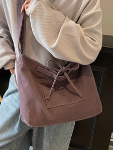 Minimalist deep purple canvas tote bag with adjustable strap and decorative drawstring bow