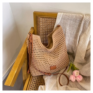 Detail of hollow woven texture and brown leather strap on minimalist tote bag