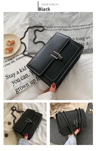 Close-up of black PU leather bag with lychee texture and H-shaped dark metal buckle