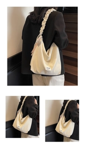 Detail view of cream tote bag featuring ruffled cloud straps and tassel accent