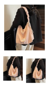 Detail of pink tote bag featuring unique cloud-shaped pleated shoulder strap and logo label