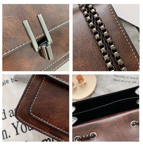 Close-up of retro brown cracked leather texture and silver metal lock on a crossbody bag