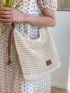 Chic hollow-out woven tote bag with brown leather straps and artistic summer vibes