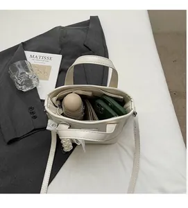 Top view of cream bucket bag interior showing capacity for umbrella and essentials
