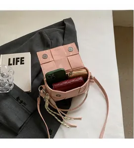 Detail of pink woven leather bag interior featuring dual magnetic snaps and spacious storage