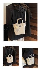 Detail of cream white patent leather bucket bag with pearl lace heart charm and logo