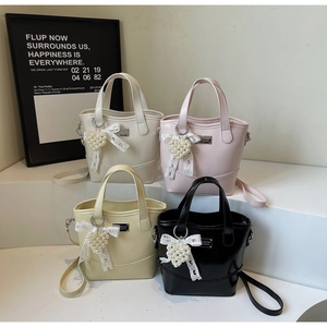 Detail of multi-color bucket bags with heart pearl charms and lace bow accessories
