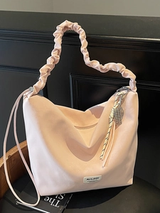Light pink large hobo bag with ruched handle and shoulder strap for daily commute
