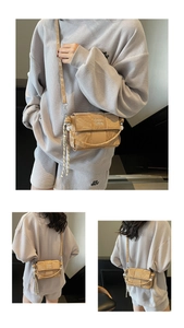 Close-up of khaki woven crossbody bag with COIH 2DN text and stylish knotted rope detail