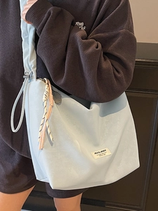 Light blue minimalist large capacity tote bag with woven rope detail and strap
