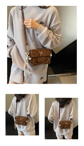 Close-up of a dark brown pleated shoulder bag featuring a woven rope tassel and logo detail