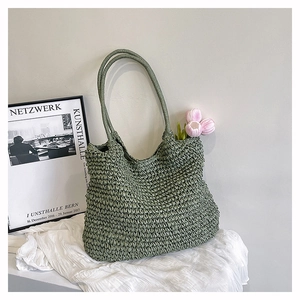 Detail of green crochet knit tote bag showing thick woven texture and large capacity