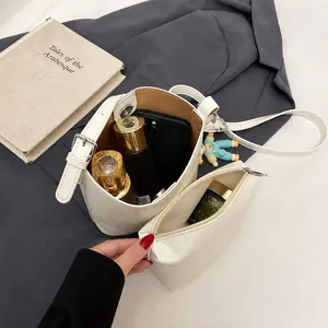 Detail showing the internal capacity of the white bucket bag with its matching pouch