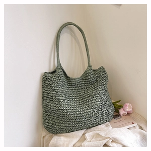 Close-up of sage green woven tote bag with detailed crochet texture and slim straps