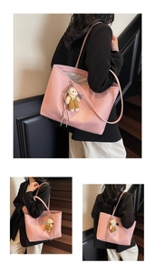 Detailed view of pink lychee pattern leather tote bag with cute brown bear charm pendant