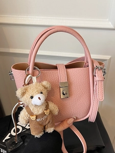 Pink lychee texture bucket bag with cute plush bear charm and silver twist lock