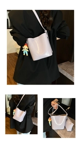 Detail of light purple glossy patent leather bucket bag with matching pouch and charm