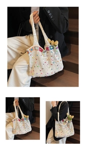 Detail of white crochet tote bag with colorful knit flowers and vibrant bead embellishments