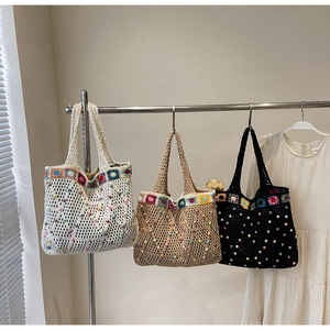 Detail of bohemian crochet tote bags with floral patterns and colorful pearl beads
