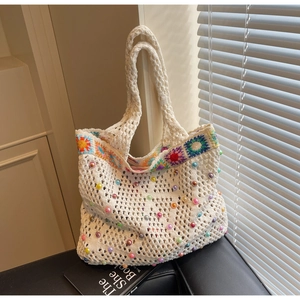 Detail of sunflower crochet tote bag showing handmade knitting texture and colorful beads