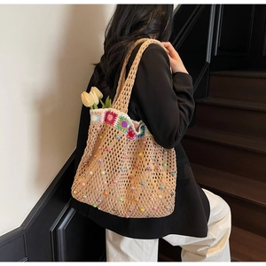 Detail of sunflower crochet tote bag with colorful beads and floral hand-knitted pattern