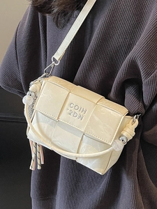 Chic cream woven square crossbody bag with marble texture and knot detail on a model