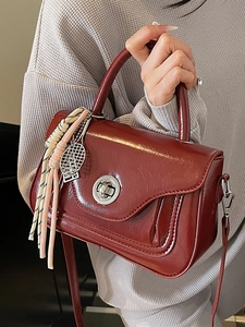 Red oil wax leather small square bag with silver hardware and tennis racket pendant